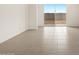 Bright living room features tile floors and a large sliding glass door to the backyard at 3175 E Hayden Rose Ave, San Tan Valley, AZ 85143