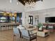 Comfortable living room open to a kitchen featuring an island and dining space in a contemporary interior at 3175 E Hayden Rose Ave, San Tan Valley, AZ 85143