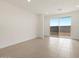 Bright living room features tile floors and a large sliding glass door to the backyard at 3175 E Hayden Rose Ave, San Tan Valley, AZ 85143