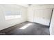 Bright bedroom with gray carpeting, window blinds, and double door closet at 6938 E Flossmoor Ave, Mesa, AZ 85208