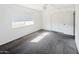 Bedroom with carpet flooring, a window providing natural light, and a closet at 6938 E Flossmoor Ave, Mesa, AZ 85208