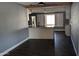 Kitchen island and dining area with dark laminate flooring at 6938 E Flossmoor Ave, Mesa, AZ 85208