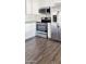 Kitchen featuring stainless steel appliances, subway tile backsplash, and wood-look flooring at 6938 E Flossmoor Ave, Mesa, AZ 85208