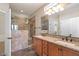 Elegant bathroom features a double vanity, granite countertop, and a tiled walk-in shower at 856 E Harmony Way, San Tan Valley, AZ 85140