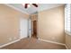 Cozy bedroom with plush carpeting, ceiling fan, and a closet for easy storage at 856 E Harmony Way, San Tan Valley, AZ 85140