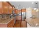 Kitchen featuring granite countertops, stainless steel appliances, and custom cabinets at 856 E Harmony Way, San Tan Valley, AZ 85140