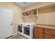 Laundry room with front load washer and dryer, ample storage, and a convenient countertop at 856 E Harmony Way, San Tan Valley, AZ 85140