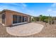 Covered patio overlooking the well-kept landscaping and desert landscape, making a great backyard oasis at 856 E Harmony Way, San Tan Valley, AZ 85140