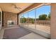 Bright sunroom with brick fireplace, ceiling fan, and large windows offering beautiful outdoor views at 856 E Harmony Way, San Tan Valley, AZ 85140