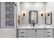 Bathroom with marble vanity, black fixtures and patterned tile at 10695 E Caribbean Ln, Scottsdale, AZ 85255