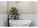 Bathroom with a free-standing soaking tub and modern fixtures at 10695 E Caribbean Ln, Scottsdale, AZ 85255