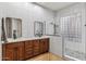 Modern bathroom with double vanity, walk-in shower, and stylish fixtures at 10695 E Caribbean Ln, Scottsdale, AZ 85255