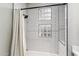 Clean bathroom with white subway tile, shower, and glass block windows at 10695 E Caribbean Ln, Scottsdale, AZ 85255