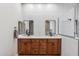 Double vanity bathroom with modern finishes and a large mirror at 10695 E Caribbean Ln, Scottsdale, AZ 85255