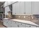 Modern kitchen with white cabinets and quartz countertops at 10695 E Caribbean Ln, Scottsdale, AZ 85255