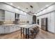 Gourmet kitchen featuring white cabinets, quartz countertops, and a large island at 10695 E Caribbean Ln, Scottsdale, AZ 85255