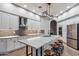 Spacious kitchen with white cabinets, an island, and stainless steel appliances at 10695 E Caribbean Ln, Scottsdale, AZ 85255