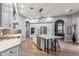 Open concept kitchen with island, stainless steel appliances and hardwood floors at 10695 E Caribbean Ln, Scottsdale, AZ 85255