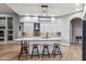 Modern kitchen with white cabinets, quartz countertops and breakfast bar at 10695 E Caribbean Ln, Scottsdale, AZ 85255