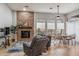 Open living space with a stone fireplace, dining area, and hardwood floors at 10695 E Caribbean Ln, Scottsdale, AZ 85255