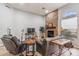 Living room with stone fireplace, comfortable seating, and large windows at 10695 E Caribbean Ln, Scottsdale, AZ 85255