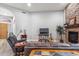 Living room with a stone fireplace, hardwood floors, and ample natural light at 10695 E Caribbean Ln, Scottsdale, AZ 85255