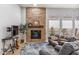 Living room boasts a stone fireplace and comfortable seating area at 10695 E Caribbean Ln, Scottsdale, AZ 85255