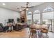 Bright and airy living room with a fireplace, dining area, and hardwood floors at 10695 E Caribbean Ln, Scottsdale, AZ 85255