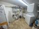 Bright laundry room with washer, dryer, shelving, and utility sink at 1498 W Pawnee Ave, Apache Junction, AZ 85119