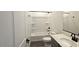 Modern bathroom with tub, gray vanity, and black fixtures at 37907 N Cowboy Ln, San Tan Valley, AZ 85140