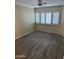 Bright bedroom with wood-look tile flooring and large window with shutters at 4330 N 5Th Ave # 106, Phoenix, AZ 85013