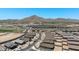 Aerial view of a new housing development against a mountain backdrop showcasing the community layout at 4922 W Hunter Trl, San Tan Valley, AZ 85144