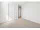 Bright bedroom featuring neutral carpet, a white door, and freshly painted white walls at 4922 W Hunter Trl, San Tan Valley, AZ 85144