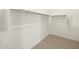 Walk-in closet with white shelving and neutral carpet at 4922 W Hunter Trl, San Tan Valley, AZ 85144