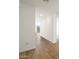 Bright hallway featuring fresh white walls, wood-look tile flooring, and an open view to the back of the home at 4922 W Hunter Trl, San Tan Valley, AZ 85144