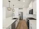 Modern kitchen featuring stainless steel appliances, white cabinets, and a large island at 4922 W Hunter Trl, San Tan Valley, AZ 85144