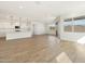 Open-concept living space with wood-look tile, natural light, and sliding door to the backyard at 4922 W Hunter Trl, San Tan Valley, AZ 85144