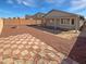 Backyard featuring a patio, brick wall and checkerboard patio set at 6556 S 258Th Dr, Buckeye, AZ 85326