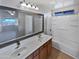 Well-lit bathroom featuring a double sink vanity, a large mirror, and a shower-tub combo at 6556 S 258Th Dr, Buckeye, AZ 85326