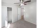 Bedroom with a ceiling fan, closet, and doorway leading to another room at 6556 S 258Th Dr, Buckeye, AZ 85326