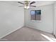 Neutral bedroom featuring a ceiling fan, a window, and carpeted floors at 6556 S 258Th Dr, Buckeye, AZ 85326