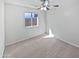 Bright, carpeted bedroom with ceiling fan and a window allowing natural light at 6556 S 258Th Dr, Buckeye, AZ 85326