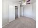 A well-lit bedroom has a closet with sliding doors and a ceiling fan at 6556 S 258Th Dr, Buckeye, AZ 85326