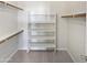 A spacious walk-in closet features built-in shelving and plenty of storage space at 6556 S 258Th Dr, Buckeye, AZ 85326