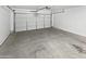 Spacious garage with concrete floor and a white garage door at 6556 S 258Th Dr, Buckeye, AZ 85326