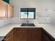 Bright kitchen with a stainless steel sink under a window offering lots of natural light at 6556 S 258Th Dr, Buckeye, AZ 85326