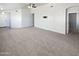 Neutral living room with carpet floors and ceiling fan, awaiting your personal touch at 6556 S 258Th Dr, Buckeye, AZ 85326