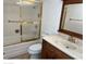 Bathroom with tub shower, vanity, and large mirror at 10861 W Venturi Dr, Sun City, AZ 85351
