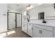 This bathroom has double sinks, a glass shower and luxury fixtures at 11632 W Beck Dr, Youngtown, AZ 85363