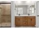 Bright bathroom features a glass shower, double vanity, and modern fixtures at 5664 N 205Th Ln, Buckeye, AZ 85396